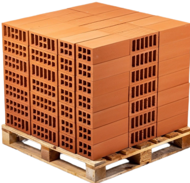 High solid concrete blocks stacked on a wooden pallet at a Ugandan construction site